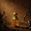 Gold bottle of oud wood perfume with spices and wood on a reflective surface