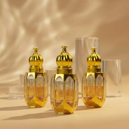 Three gold perfume bottles labeled 'Oud Saffron', 'White Oud', and 'Ameer Ul Oud' with floral and spice decorations on a reflective surface.